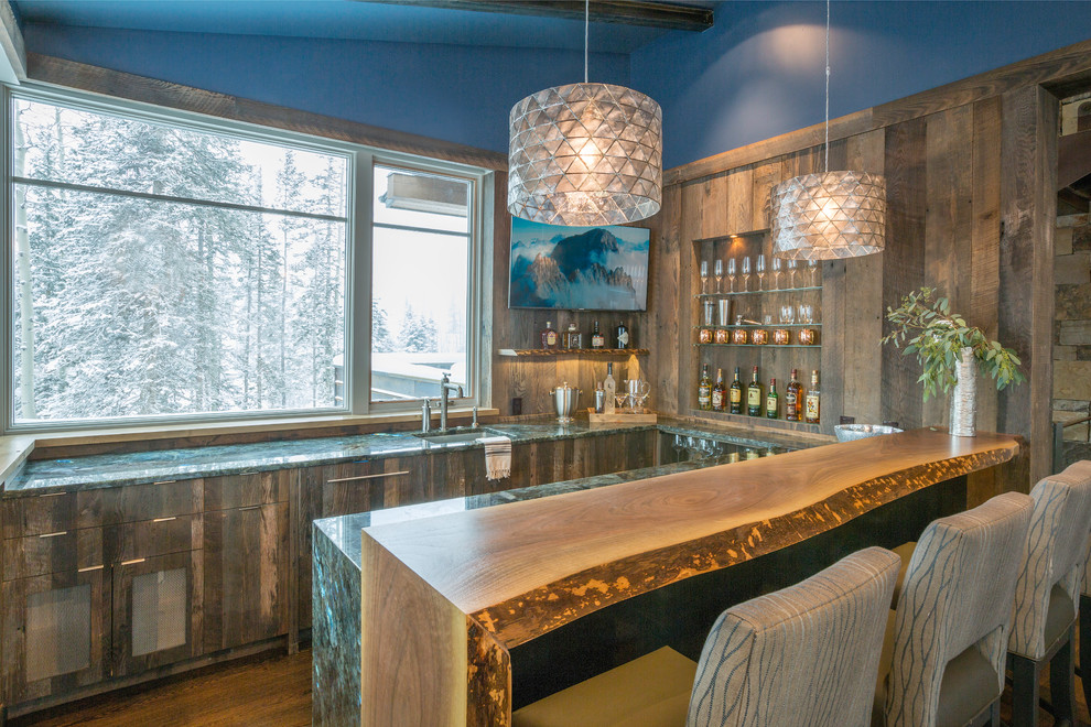 Mid-sized country u-shaped seated home bar in Denver with an undermount sink, flat-panel cabinets, distressed cabinets, granite benchtops, brown splashback, medium hardwood floors and turquoise benchtop.