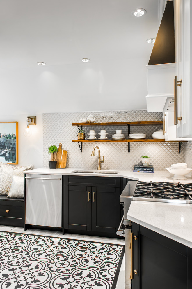 Eat-in kitchen - small transitional l-shaped porcelain tile and multicolored floor eat-in kitchen idea in Vancouver with an undermount sink, shaker cabinets, black cabinets, solid surface countertops, porcelain backsplash, stainless steel appliances, no island and gray backsplash