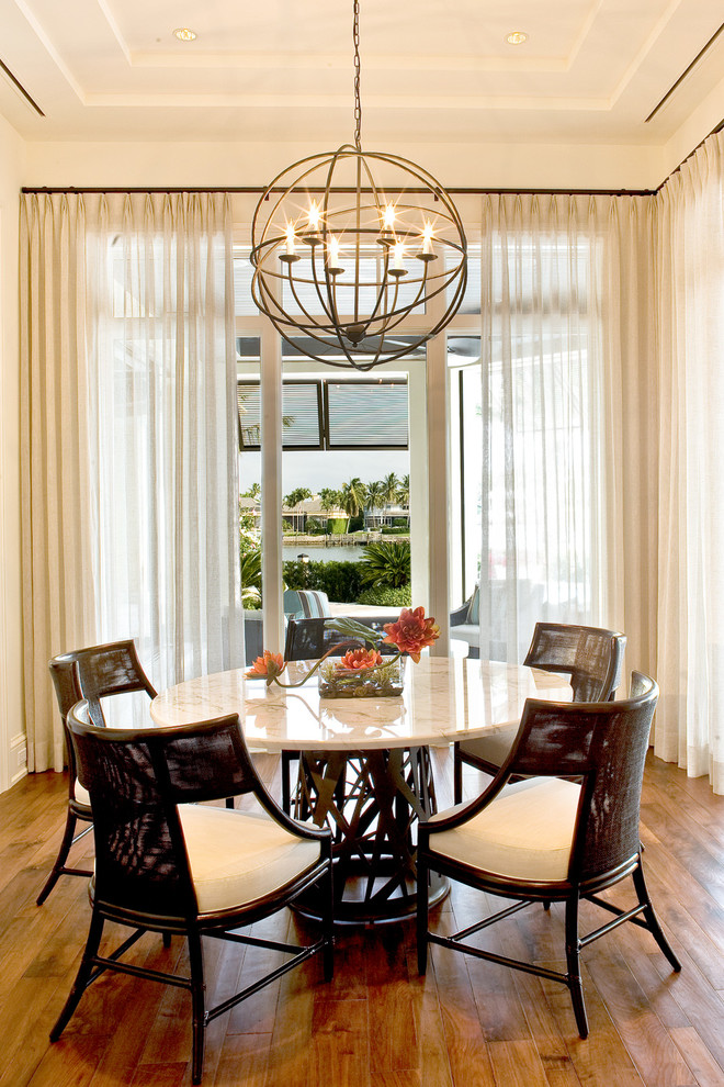 Design ideas for a large transitional dining room in Miami with beige walls and medium hardwood floors.