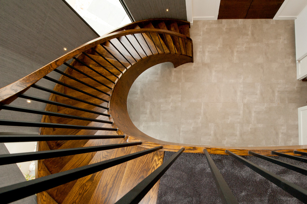 Design ideas for a mid-sized contemporary wood curved staircase in Melbourne with open risers.