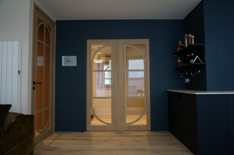 Salle de séjour?[Aménagement de salle de séjour With un mur bleu, parquet clair, aucune cheminée, aucun téléviseur, un sol beige and éclairage.]:[Aménagement de salles de séjour With un mur bleu, parquet clair, aucune cheminée, aucun téléviseur, un sol beige and éclairage.]