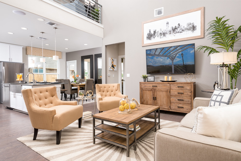 This is an example of a mid-sized contemporary open concept living room in Austin with grey walls, medium hardwood floors and a wall-mounted tv.