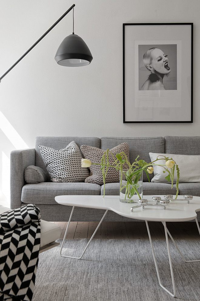 Inspiration for a contemporary formal living room in Gothenburg with white walls, light hardwood floors and no fireplace.
