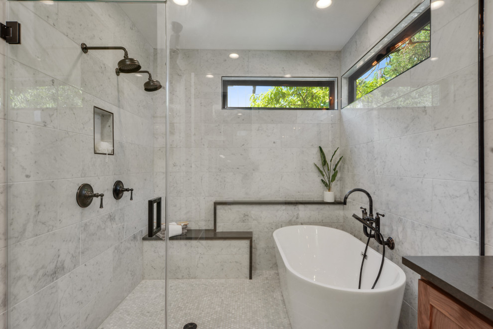 Inspiration for a master white tile and marble tile ceramic tile, gray floor and double-sink bathroom remodel in Austin with recessed-panel cabinets, brown cabinets, an undermount sink, a hinged shower door, gray countertops and a built-in vanity