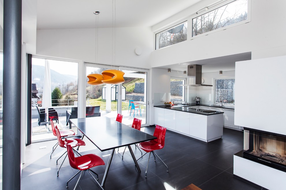 Inspiration for a large contemporary u-shaped open plan kitchen in Munich with an integrated sink, flat-panel cabinets, white cabinets, white splashback, stainless steel appliances, onyx benchtops and no island.