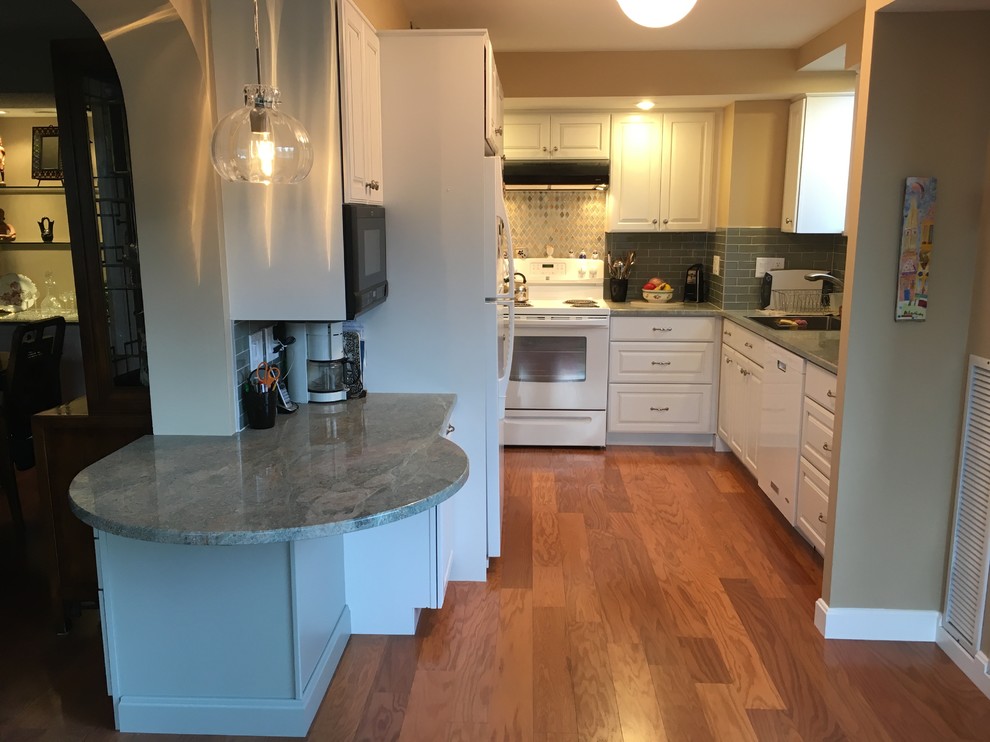 Kitchen - transitional u-shaped medium tone wood floor kitchen idea in Boston with a drop-in sink, raised-panel cabinets, white cabinets, granite countertops, green backsplash, glass tile backsplash, white appliances, a peninsula and green countertops