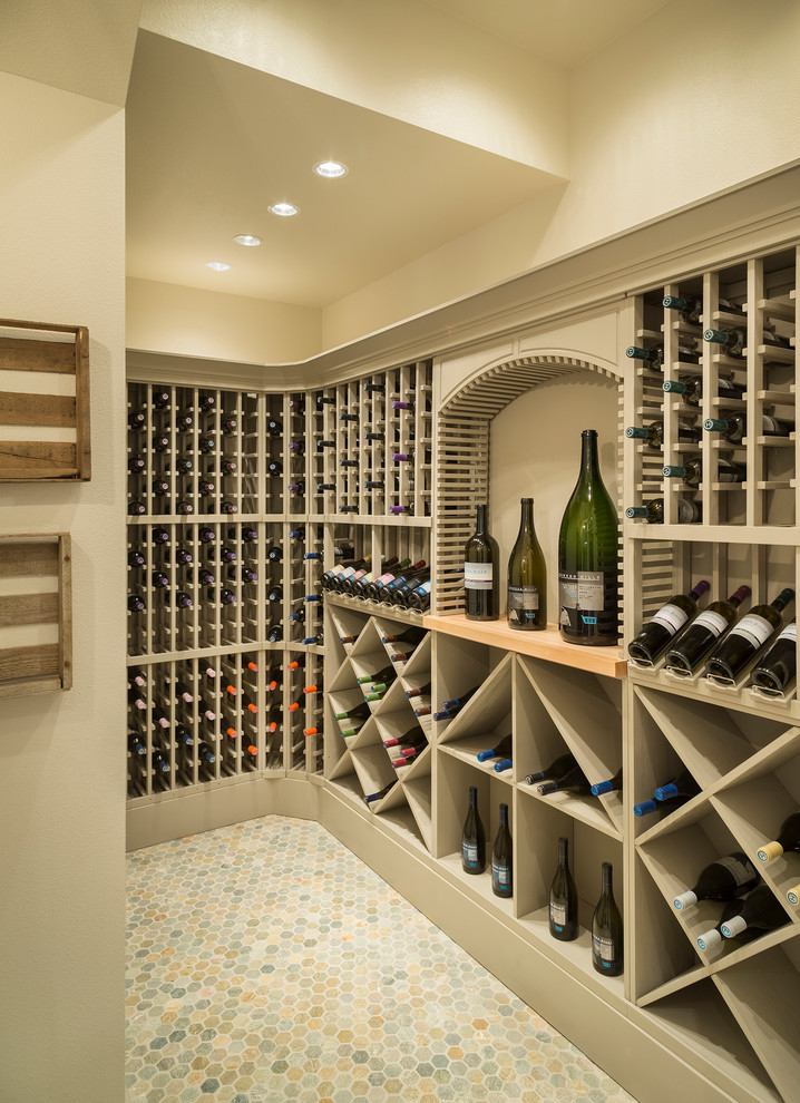 This is an example of a transitional wine cellar in Portland with storage racks and multi-coloured floor.