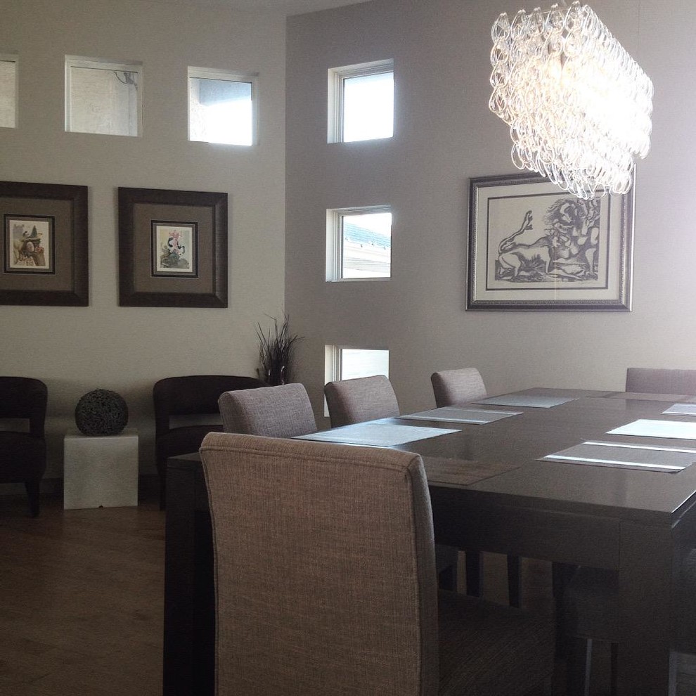 Small contemporary separate dining room in Other with grey walls and light hardwood floors.