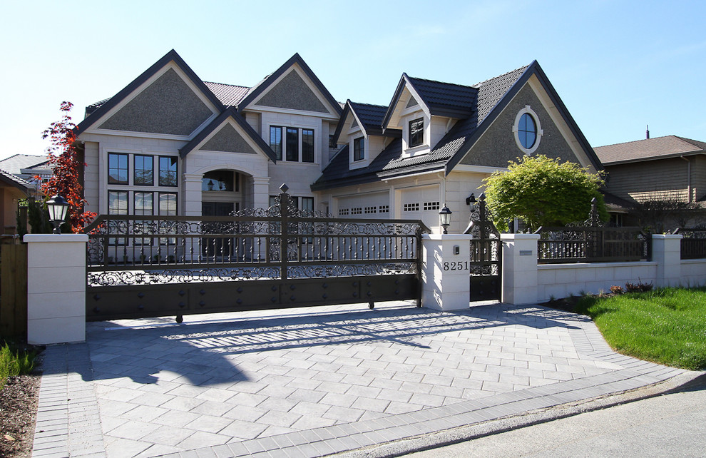This is an example of a large traditional two-storey multi-coloured exterior in Vancouver with mixed siding.