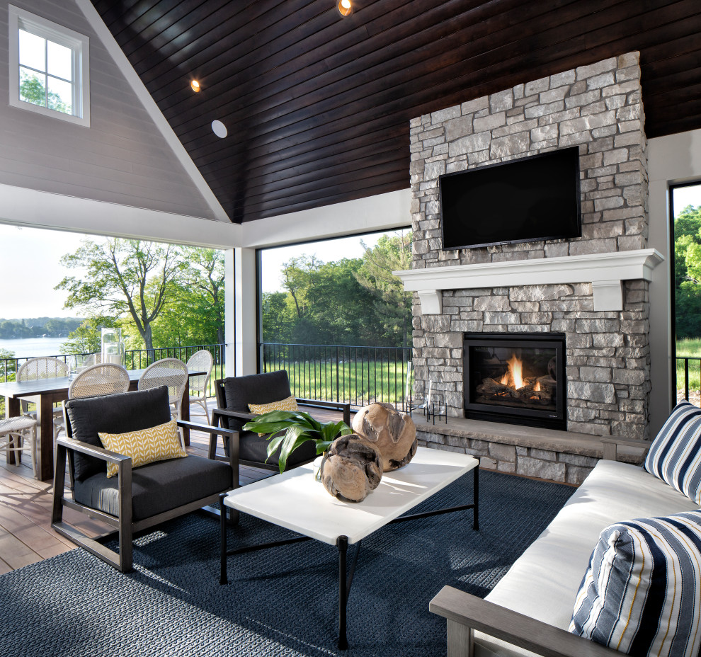 Inspiration for a mid-sized transitional backyard patio remodel in Minneapolis with a fireplace, decking and a roof extension