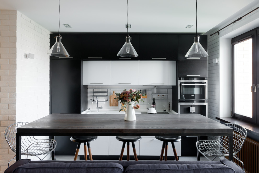 Inspiration for a contemporary single-wall open plan kitchen in Moscow with flat-panel cabinets, black cabinets and white splashback.