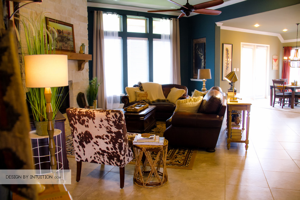 Example of a large mountain style open concept living room design in Houston with blue walls and a tv stand