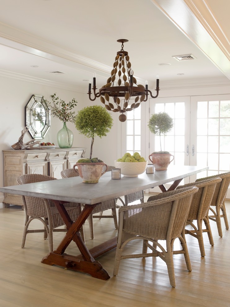 Beach style dining room in New York with white walls and light hardwood floors.