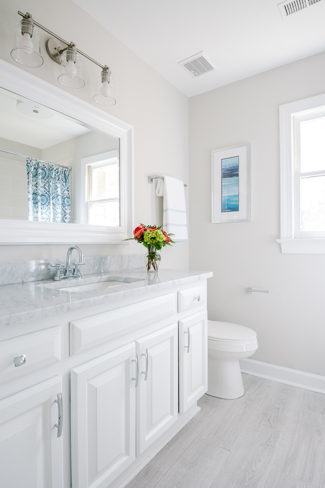 Design ideas for a traditional 3/4 bathroom in Charlotte with white cabinets.