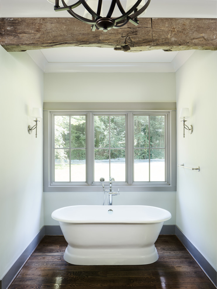 Inspiration for a mid-sized country master bathroom in Birmingham with raised-panel cabinets, beige cabinets, a freestanding tub, an alcove shower, a two-piece toilet, blue walls, medium hardwood floors, an undermount sink and marble benchtops.