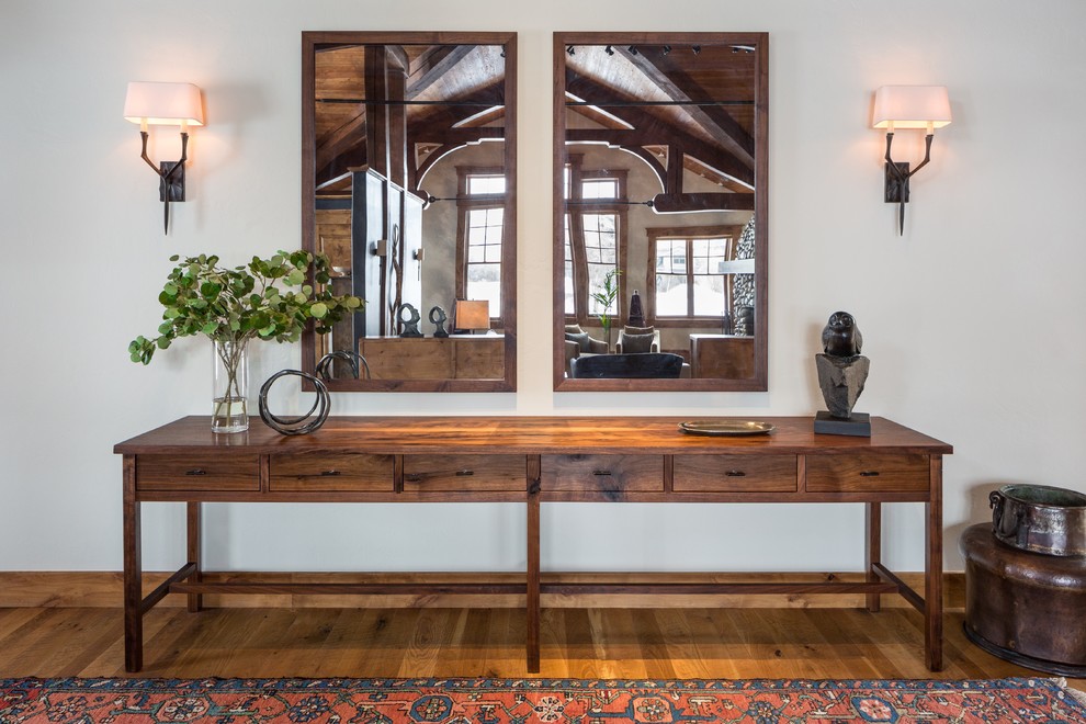 Example of a large transitional light wood floor foyer design with white walls