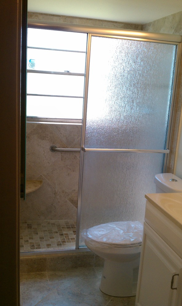 Alcove shower - mid-sized transitional master ceramic tile alcove shower idea in Miami with raised-panel cabinets, white cabinets, a two-piece toilet and beige walls