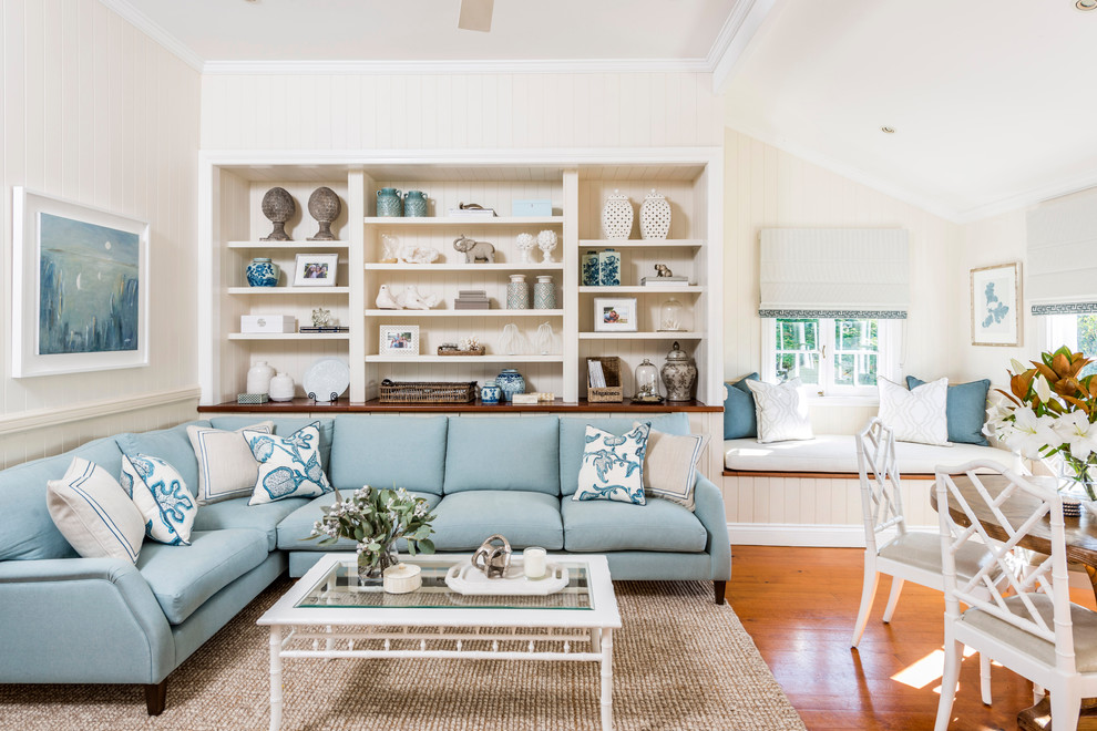 Mid-sized beach style open concept living room in Brisbane with medium hardwood floors and white walls.