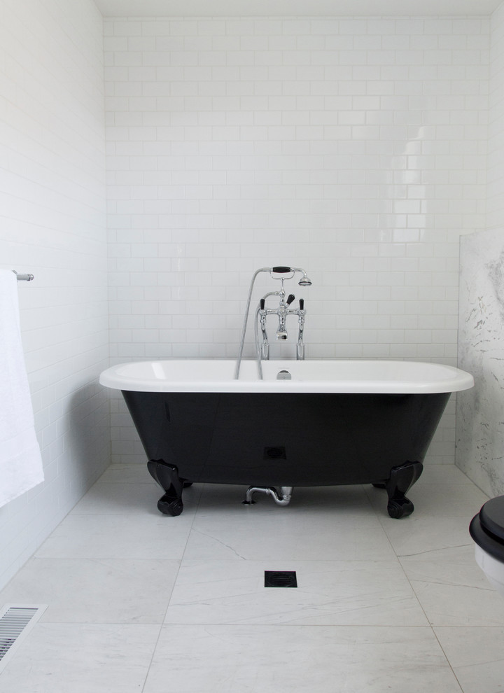 Inspiration for a large traditional master bathroom in Sydney with furniture-like cabinets, black cabinets, a claw-foot tub, a two-piece toilet, white tile, porcelain tile, white walls, marble floors, an undermount sink and marble benchtops.