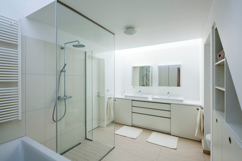 This is an example of a large contemporary master bathroom in Frankfurt with a vessel sink, white cabinets, beige tile, white walls, a curbless shower, open cabinets and ceramic tile.