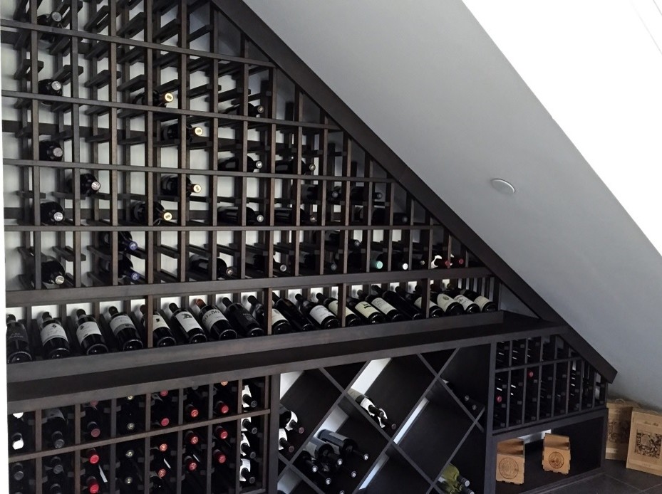 Photo of a small traditional wine cellar in Los Angeles with display racks.