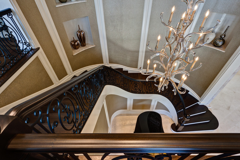 Photo of an expansive traditional wood curved staircase in Miami with painted wood risers.