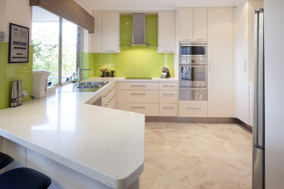 Inspiration for a modern kitchen in Perth with a double-bowl sink, flat-panel cabinets, white cabinets, quartz benchtops, green splashback, glass sheet splashback, stainless steel appliances and white benchtop.