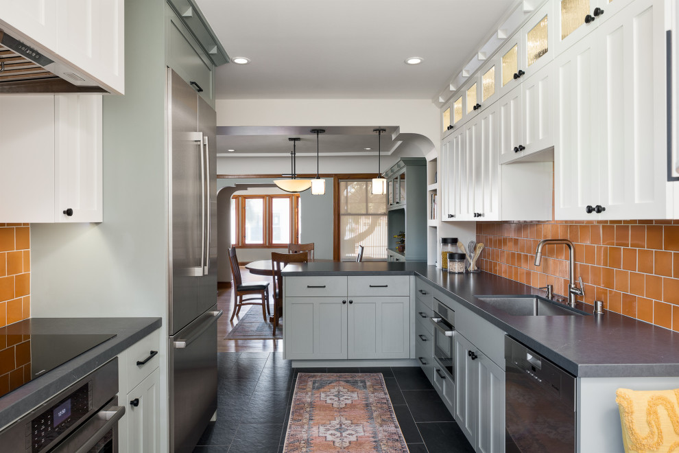 Eat-in kitchen - mid-sized transitional galley porcelain tile and black floor eat-in kitchen idea in San Francisco with an undermount sink, recessed-panel cabinets, green cabinets, quartz countertops, orange backsplash, ceramic backsplash, stainless steel appliances and black countertops