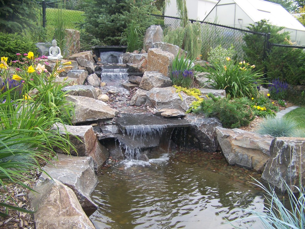 This is an example of a mid-sized rustic full sun backyard formal garden in Calgary for summer.