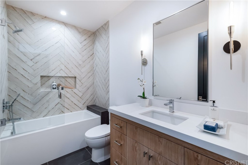 Design ideas for a large modern bathroom in Los Angeles with flat-panel cabinets, black cabinets, a freestanding bath, a one-piece toilet, yellow tiles, marble tiles, white walls, marble flooring, a submerged sink, marble worktops, white floors, a hinged door, white worktops, a shower bench, a single sink, a built in vanity unit and tongue and groove walls.
