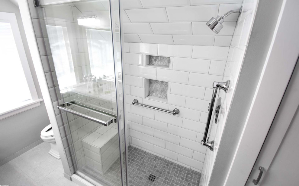 Design ideas for a small transitional 3/4 bathroom in Portland with beaded inset cabinets, grey cabinets, an alcove shower, a two-piece toilet, white tile, subway tile, grey walls, ceramic floors, an undermount sink, engineered quartz benchtops, grey floor, a sliding shower screen, white benchtops, a shower seat, a double vanity and a built-in vanity.