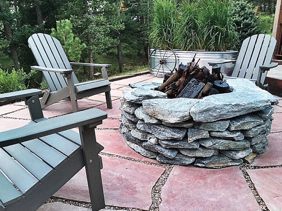 Photo of a mid-sized rustic backyard landscaping in Denver with a fire pit.