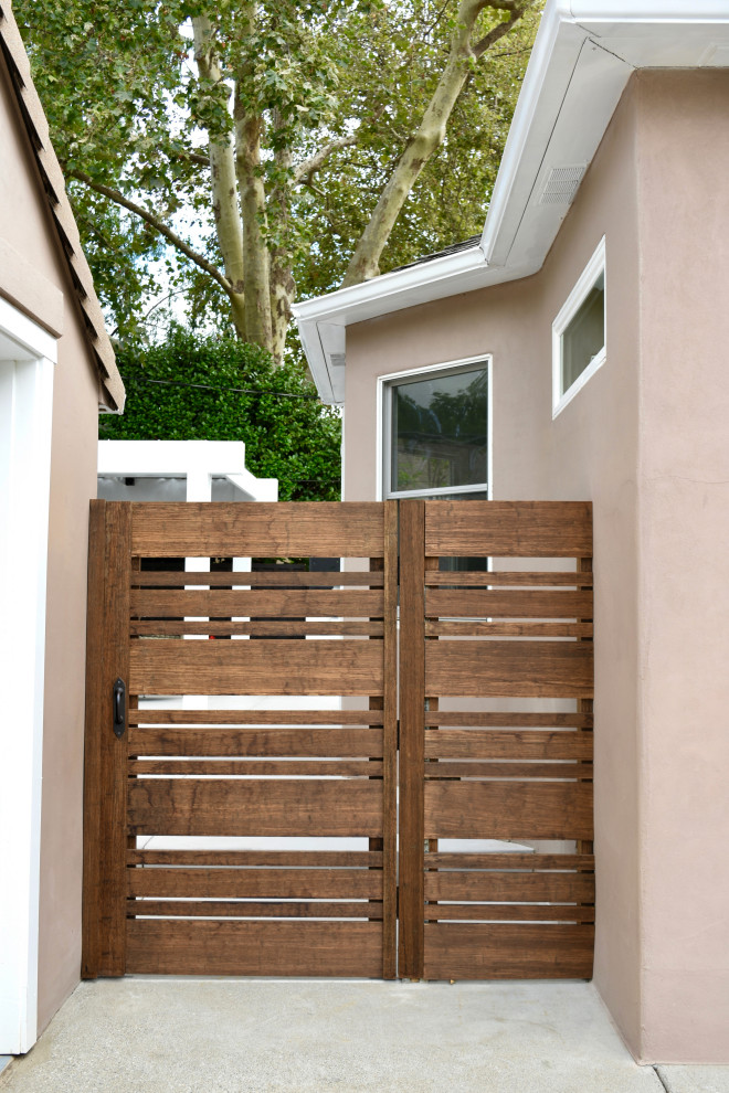 Inspiration for a mid-sized transitional backyard wood fence landscaping in San Francisco with a pergola.