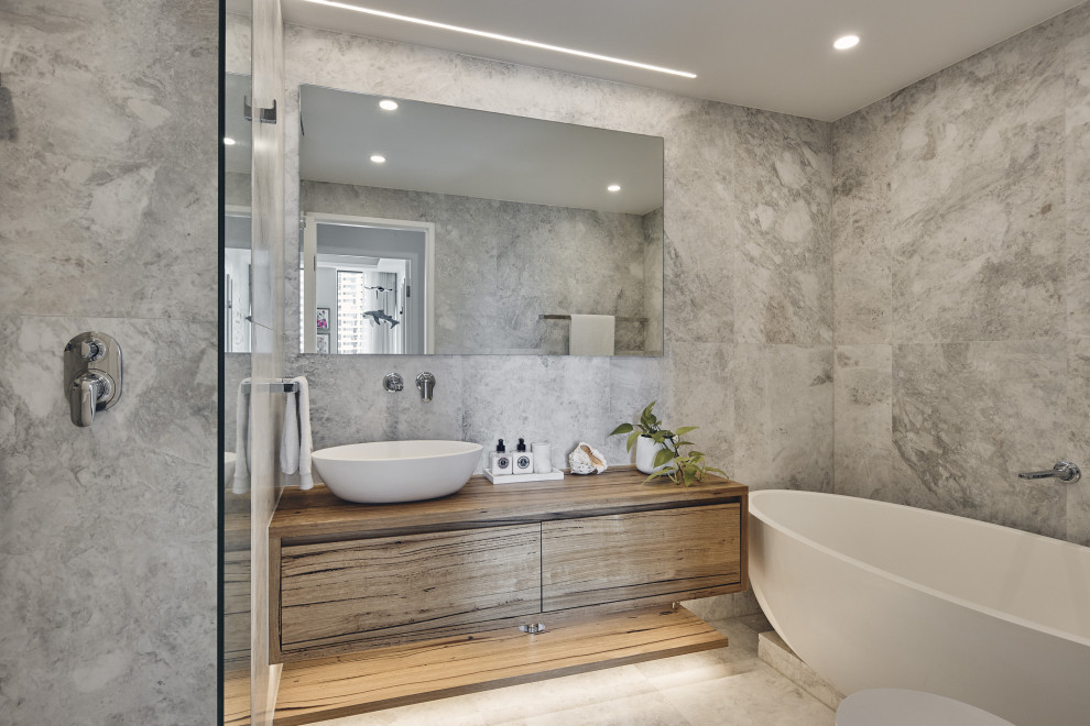 Design ideas for a bathroom in Sydney with medium wood cabinets, a freestanding bath, a walk-in shower, a one-piece toilet, white tiles, marble tiles, marble flooring, wooden worktops, white floors and a floating vanity unit.