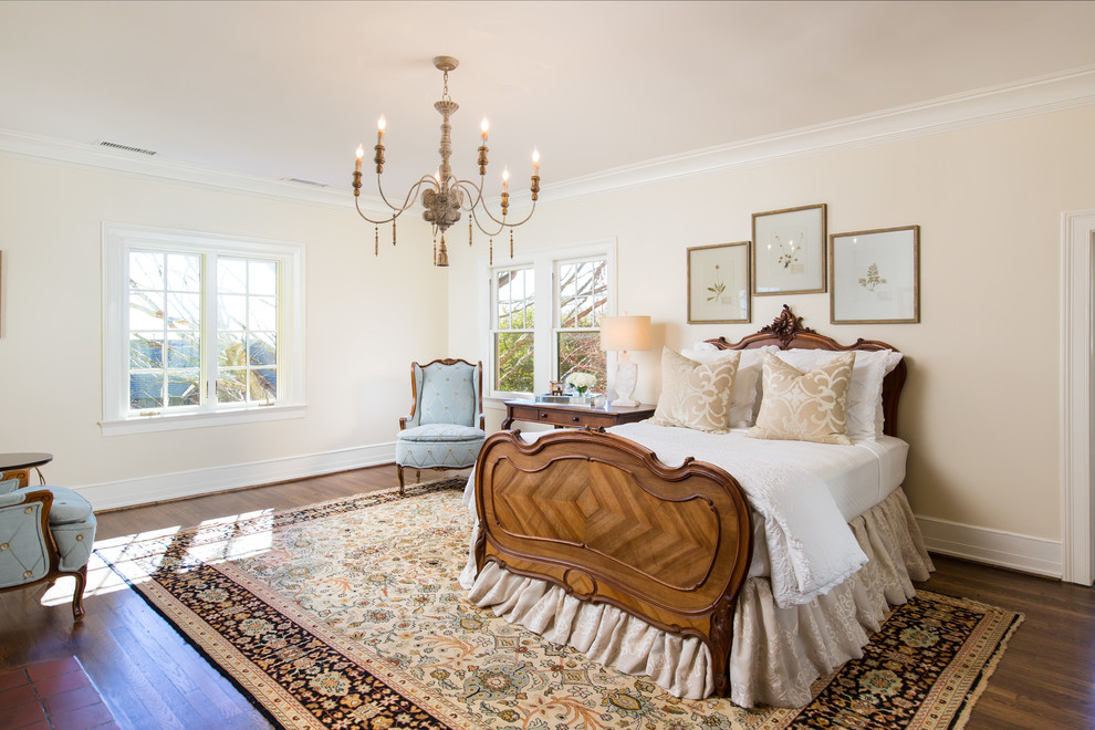 Mid-sized country master bedroom in Birmingham with beige walls, medium hardwood floors, no fireplace and brown floor.