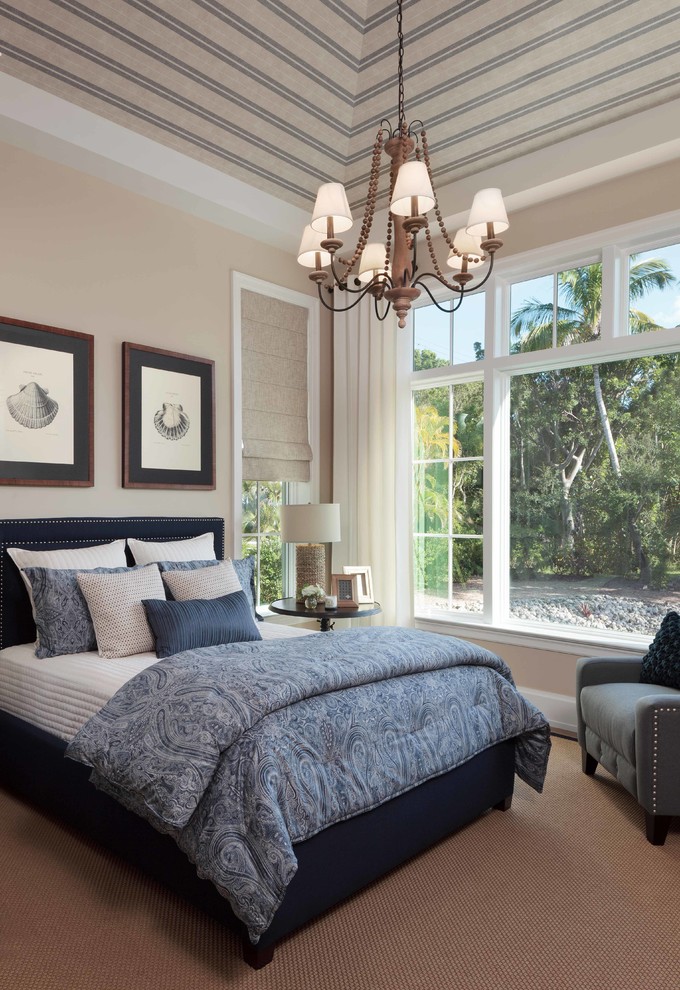 Large classic master bedroom in Miami with beige walls and light hardwood flooring.