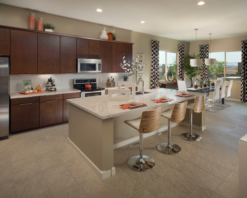 Inspiration for a transitional eat-in kitchen in Phoenix with flat-panel cabinets, dark wood cabinets and stainless steel appliances.