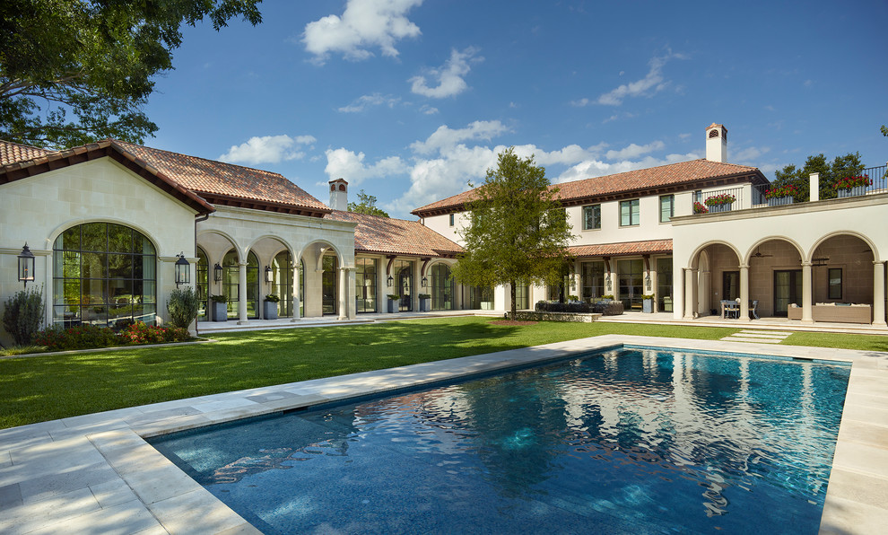 Mediterranean two-storey beige house exterior in Dallas with a hip roof and a tile roof.