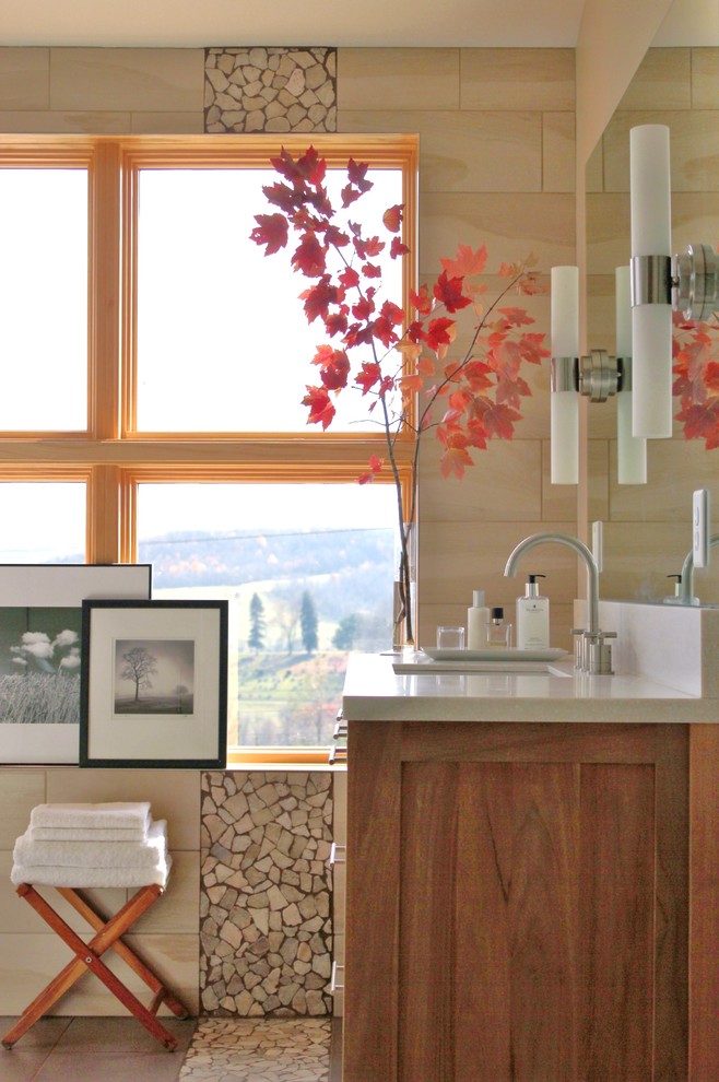 Transitional bathroom photo with flat-panel cabinets, medium tone wood cabinets, solid surface countertops and beige walls