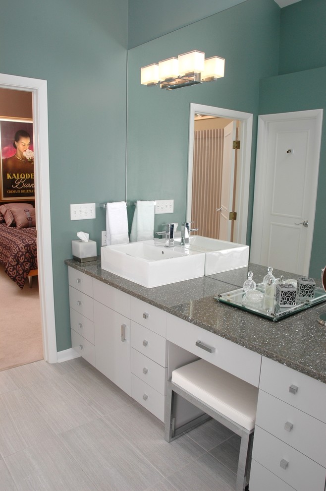 Photo of a large contemporary master bathroom in Cincinnati with flat-panel cabinets, white cabinets, a freestanding tub, an open shower, beige tile, porcelain tile, green walls, porcelain floors, a vessel sink, quartzite benchtops and beige floor.