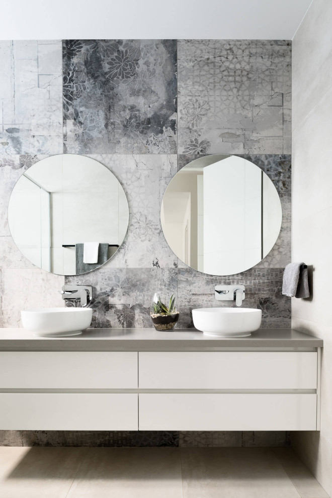 Photo of a contemporary bathroom in Melbourne with flat-panel cabinets, white cabinets, gray tile, a vessel sink, grey floor, grey benchtops and a double vanity.
