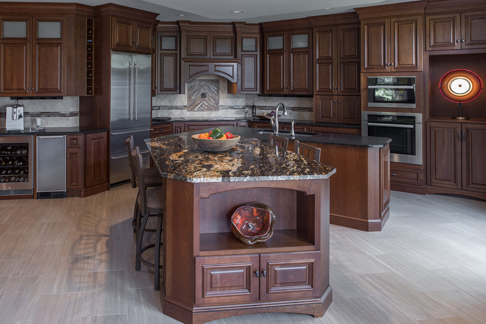 Inspiration for a large transitional kitchen remodel with an undermount sink, raised-panel cabinets, stainless steel appliances and an island