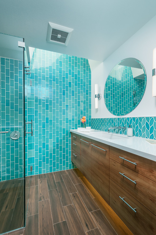 Photo of a mid-sized modern master bathroom in San Francisco with flat-panel cabinets, medium wood cabinets, a curbless shower, a one-piece toilet, green tile, ceramic tile, white walls, porcelain floors, an undermount sink and engineered quartz benchtops.