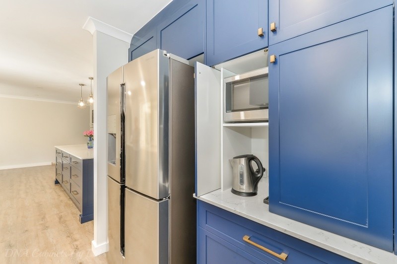 Inspiration for a transitional galley eat-in kitchen with a double-bowl sink, blue cabinets, with island and stainless steel appliances.