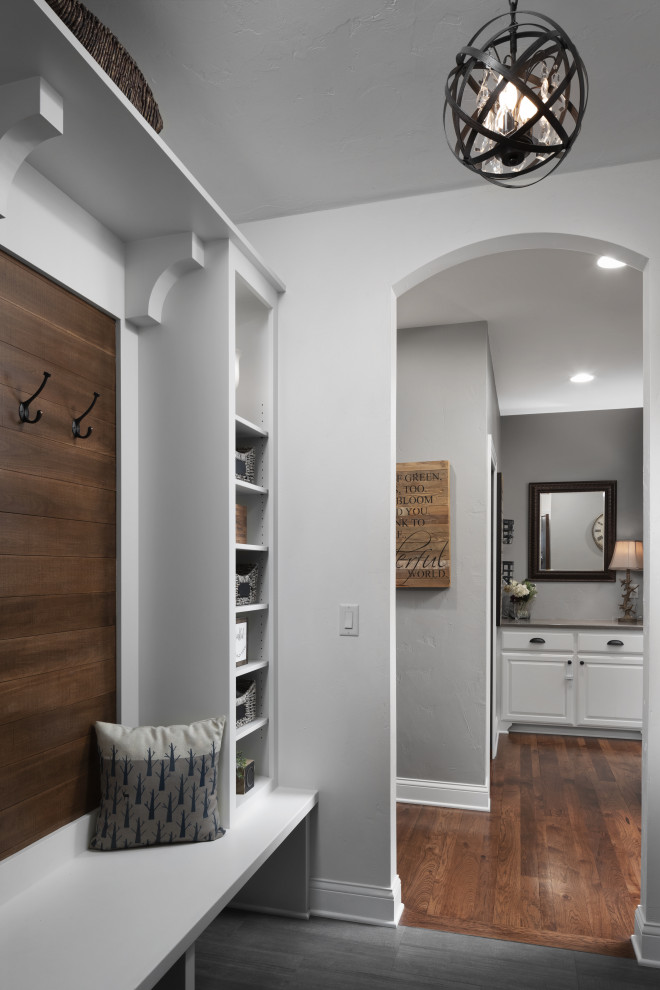 Inspiration for a small transitional hallway in Milwaukee with grey walls, medium hardwood floors, brown floor and planked wall panelling.