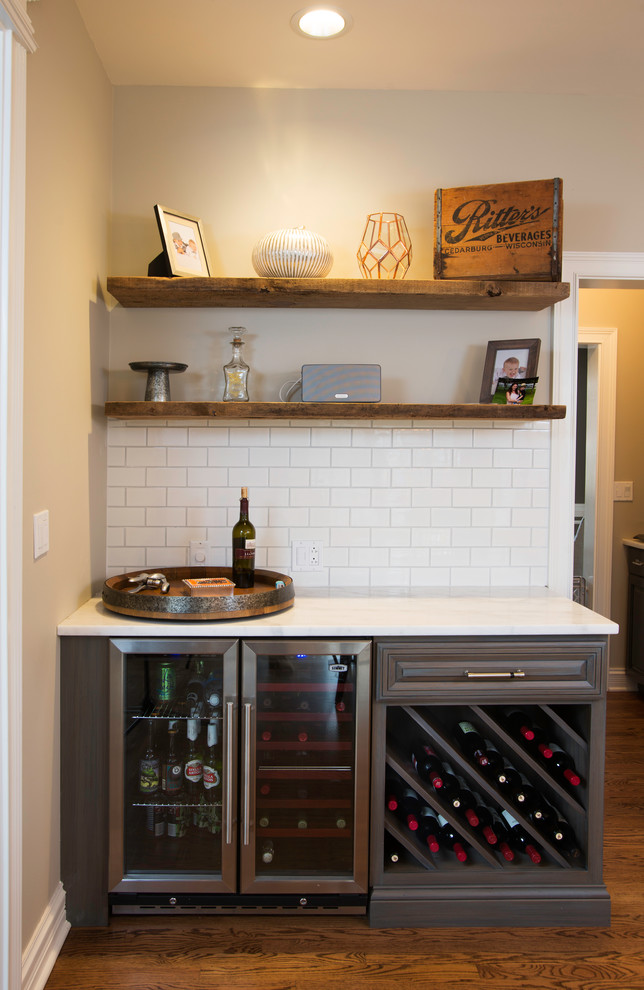 Eat-in kitchen - large transitional u-shaped medium tone wood floor eat-in kitchen idea in Chicago with white cabinets, white backsplash, stainless steel appliances and an island