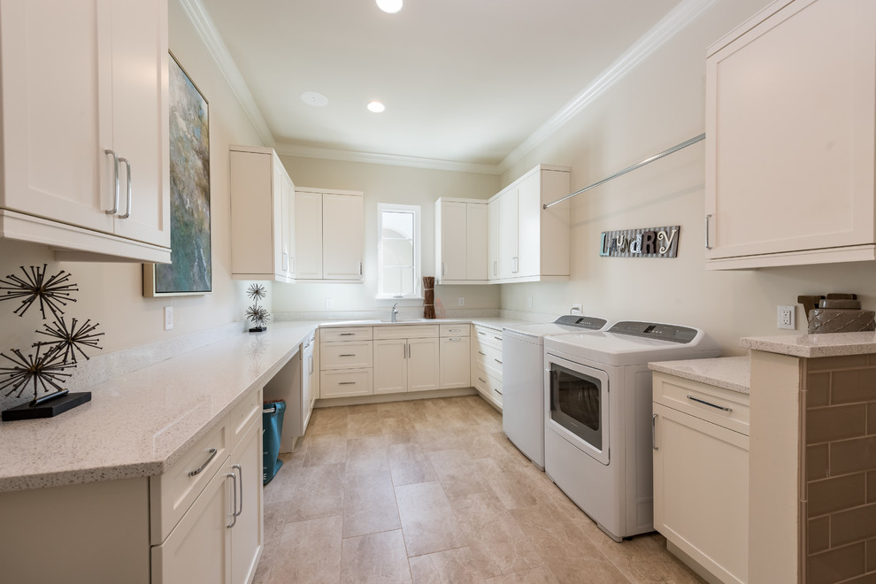 Large mediterranean u-shaped dedicated laundry room in Orlando with an undermount sink, shaker cabinets, white cabinets, ceramic floors, a side-by-side washer and dryer and white benchtop.