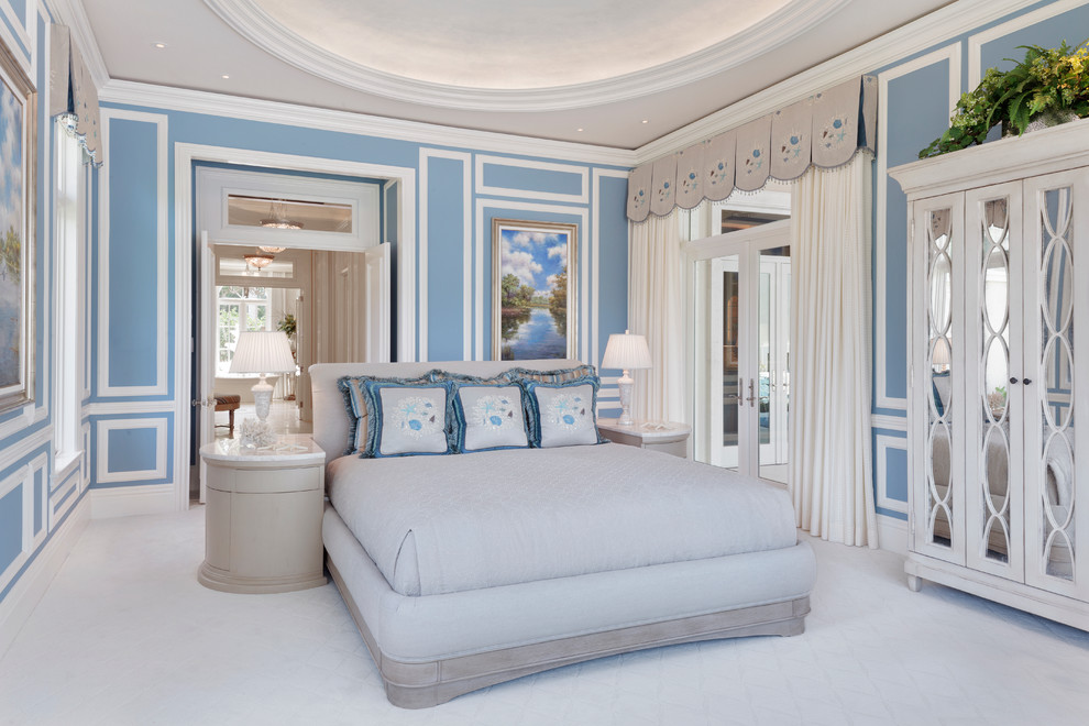 Transitional bedroom in Miami with blue walls.