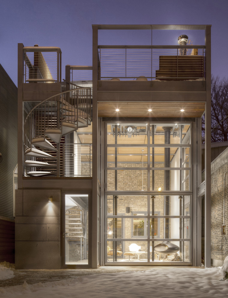 Photo of a small contemporary two-storey glass house exterior in Chicago.