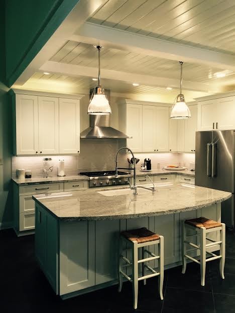 Inspiration for a large craftsman l-shaped porcelain tile open concept kitchen remodel in Austin with an undermount sink, recessed-panel cabinets, white cabinets, granite countertops, white backsplash, ceramic backsplash, stainless steel appliances and an island